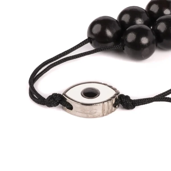 Komboloi grec en bois d'ébène -Vue rapprochée du médaillon en forme d'oeil porte-bonheur - Photyne