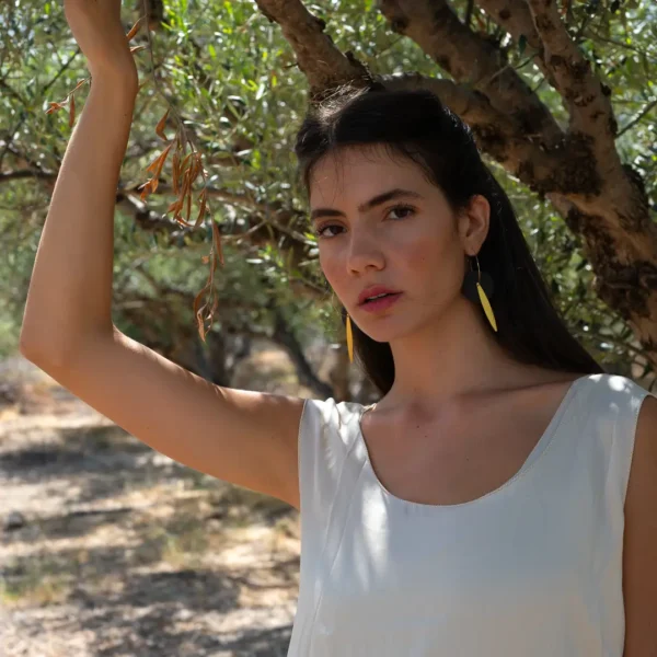 Créoles Eléa par Photyne, disques de céramique noire et éléments dorés en forme de feuilles d'olivier.