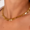 gros plan sur collier composé de multiples médaillons dorés - Photyne